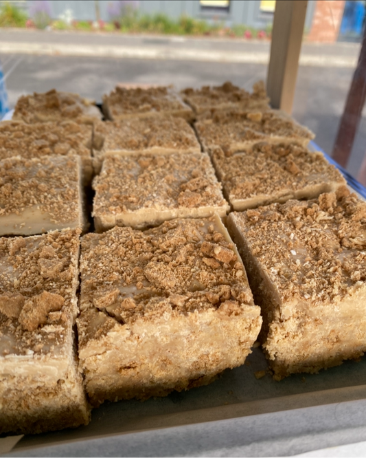 A Slav traybake of gluten free biscoff slice sectioned and for sale