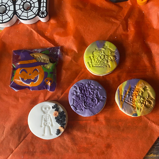 Halloween-themed stamps on an orange paper background